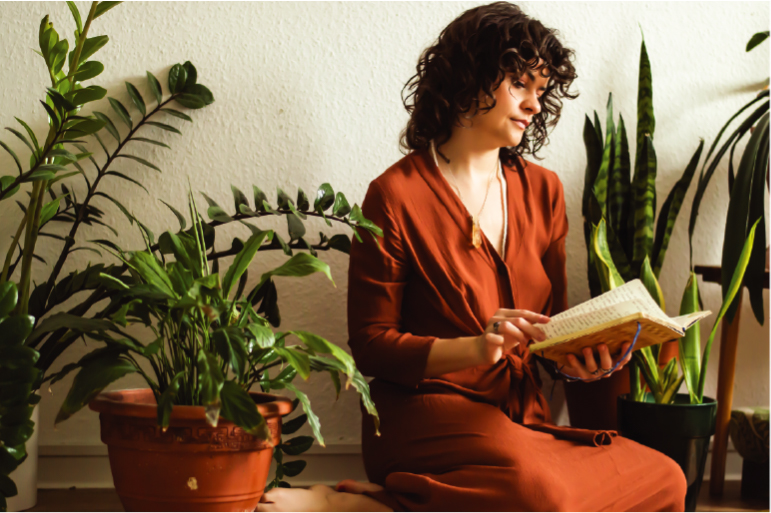 Paulina among plants reading a book